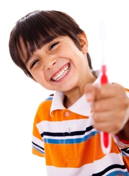 Happy young boy showing the toothbrush on isoalted background