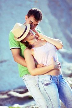 Young couple hugging passionately on the beach