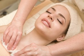 Young beautiful woman having facial massage