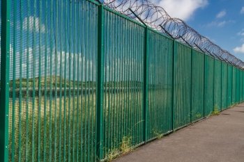 Boundary area of ferry terminal. Fence and Razor wire. Dunkirk, France, Europe. Ferries to the UK.