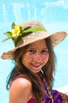 Little girl wearing a hat near pool