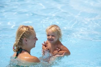Child having fun in water with mom.
