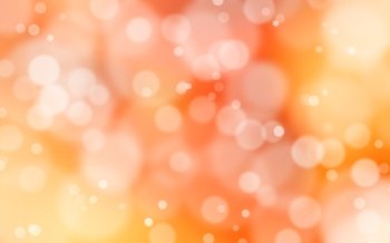 A yellow and red bokeh background with white flares