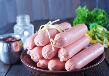 sausages on plate and on a table