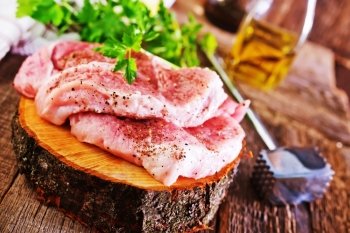 raw meat  with pepper on the wooden board