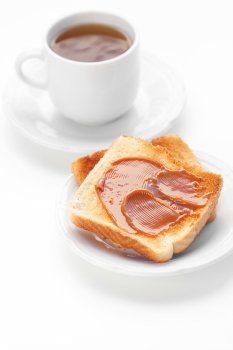 tea and toast with caramel isolated on white