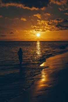 Young Woman Looking Sunset on the Beach