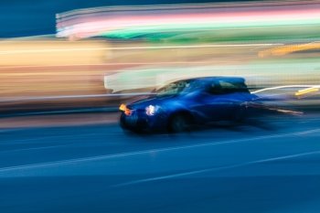 Blue Sports Car in a Blurred City Scene