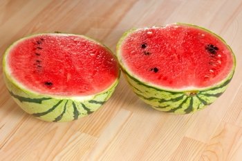 fresh ripe watermelon sliced on a  wood table 