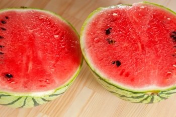 fresh ripe watermelon sliced on a  wood table 