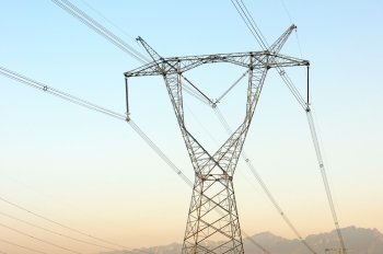 High voltage transmission lines with blue sky as background