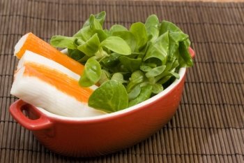 surimi and salad. a diet cup withe fresh salad and surimi