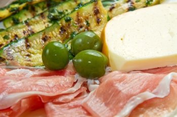 raw ham with grilled zucchini, cheese and olives