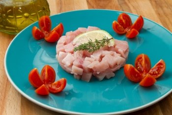swordfish tartar with fresh tomato and lemon slice 