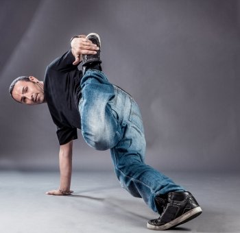 photo of break dancer who is performing his move 
