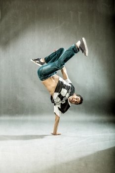 photo of boy who is posing his dance movements in front of the camera