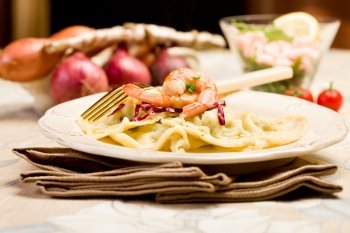 delicious italian homemade ravioli with shrimps and golden fork