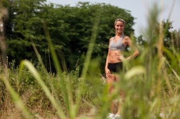 Photo of smiling blonde woman with running outfit