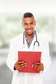 Smiling afro american doctor with flip chart