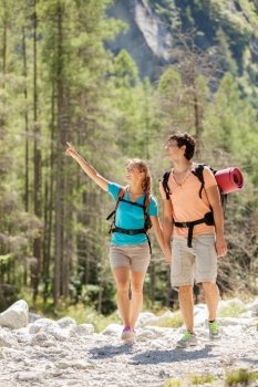 Young couple is doing trekking in the mountains