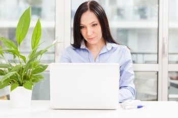 Photo of caucasian businesswoman with notebook working in home office