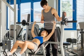 Photo of caucasian woman doing dumbbell exercise in gym