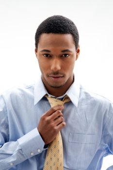 Handsome African American male in blue shirt and yellow tie, isolated