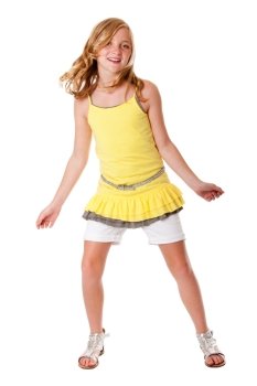 Beautiful cute blond girl having fun dancing fashion dressed in layered yellow shirt, white shorts and belt, isolated.