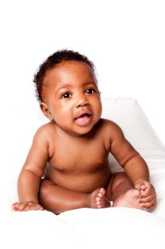 Beautiful happy cute African baby infant sitting, on white.