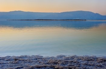 Landscape Dead Sea shortly before dawn, salt, water and the Jordanian mountains in the background.