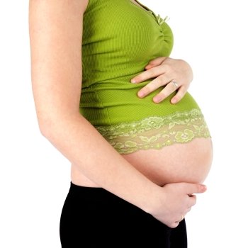 Nine month pregnant woman holding belly isolated over white background.