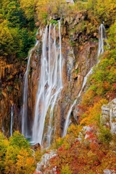 High mountain waterfall in autumn scenery