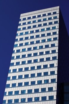Office building architecture against high contrast blue sky