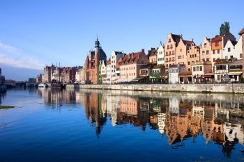 Scenic view with reflection on water of the Old Town of Gdansk in Poland by the Motlawa river
