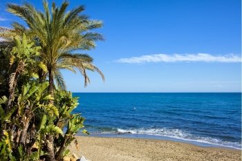 Picturesque tranquil scenery of a sandy beach and Mediterranean Sea in Marbella, Andalusia region, Costa del Sol, Spain