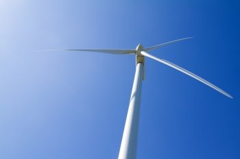 A wind turbine under clear blue sky