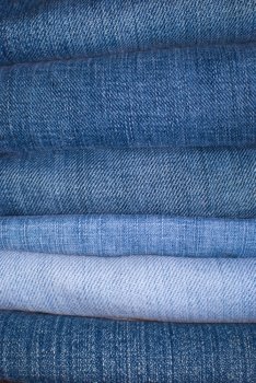 Jeans Background - Stack of Jeans Trousers in Different Shades of Blue