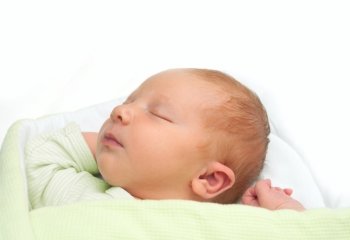 Closeup of Sleeping Newborn Baby on White Background