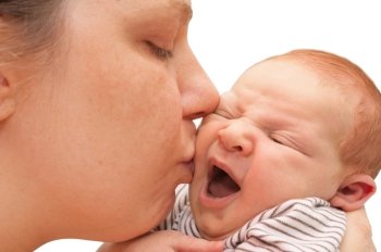 Mother Kissing Yawning Newborn Baby - on White Background