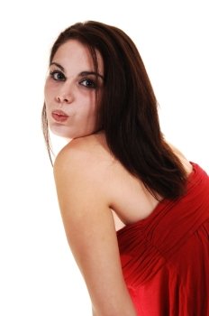 An young woman in a red dress standing in the studio for a portraitshot, smiling into the camera, for white background.