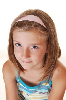 Closeup of a very pretty young girl with blond hair, looking into thethe camera, on white background.