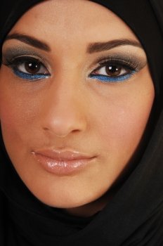 A pretty and young teen girl with a black headscarf and nice makeuplooking into the camera in closeup, for white background.