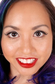 A closeup picture of a beautiful Asian’s woman’s face with big eye’s and red lips.