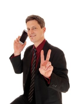 A closeup shoot of a man his cell phone on his ear and sign victory withtwo fingers, isolated for white background.
