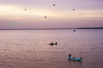 Sri lankan fishermans catching fish at sunset