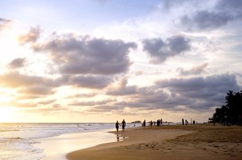 People on the ocean beach at sunset. Sri Lanka