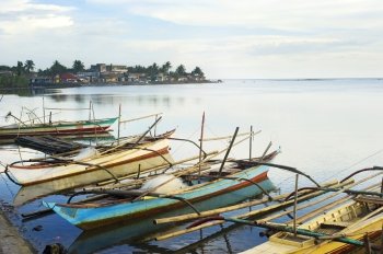 Tropical landscape with traditional Philippines fishermans boats and village. Donsol, Philippines