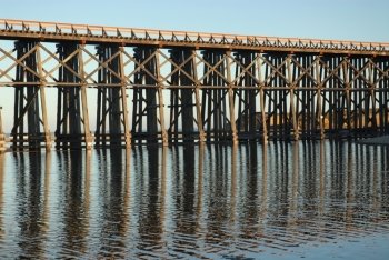 Railroad trestle reflected in the water, Fort Bragg, California
