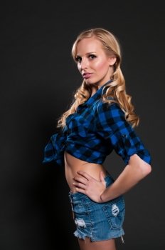 Blue eyed blonde in a plaid shirt and denim shorts