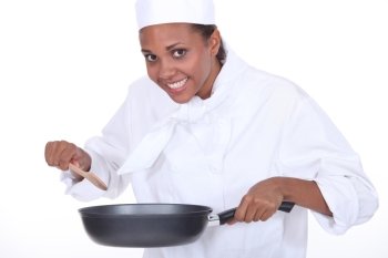 Female chef holding saucepan